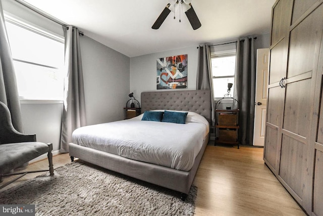 bedroom featuring light wood-style flooring and a ceiling fan