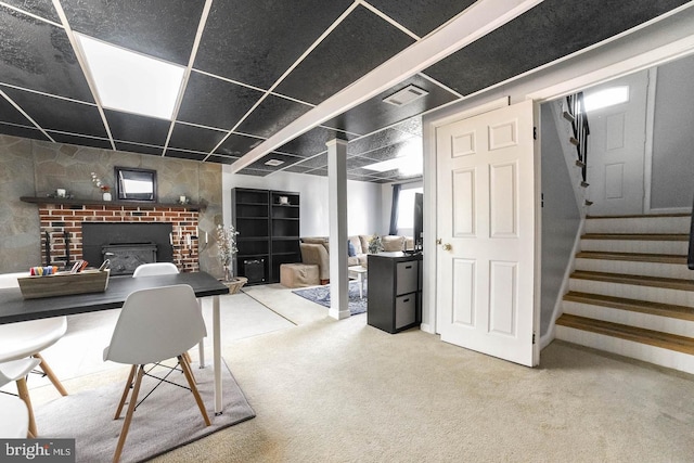 basement with carpet, visible vents, and stairway