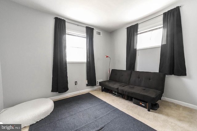 sitting room with carpet, visible vents, and baseboards