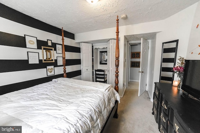 bedroom featuring a textured ceiling and light colored carpet