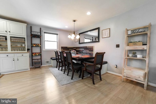 dining area featuring baseboards, visible vents, an inviting chandelier, light wood-style floors, and recessed lighting