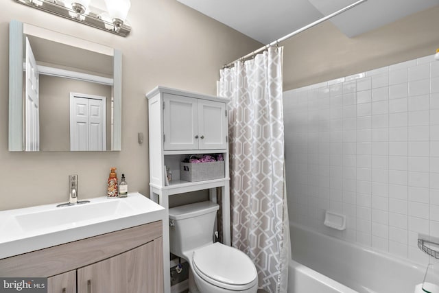 bathroom featuring toilet, vanity, and shower / bath combo