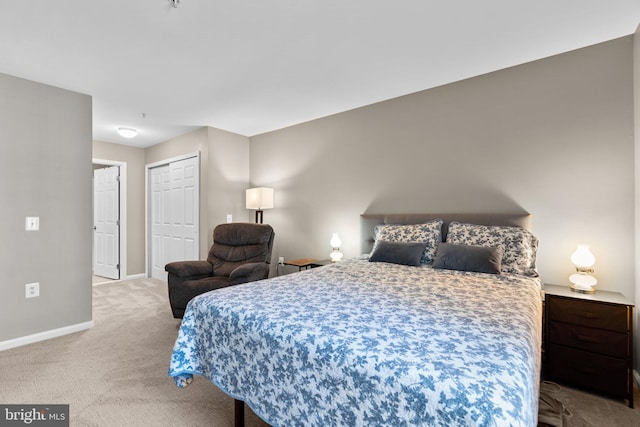 carpeted bedroom featuring a closet and baseboards