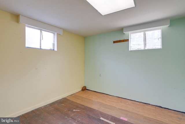 below grade area with wood-type flooring and baseboards