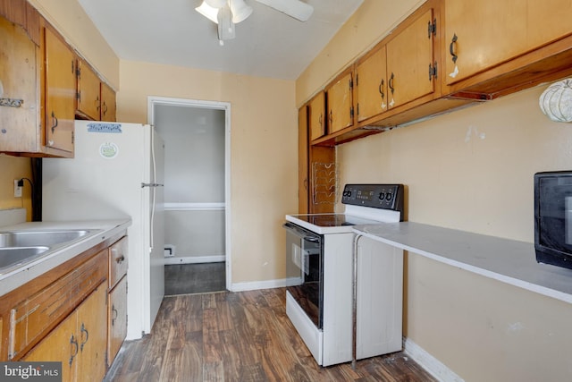 kitchen featuring white appliances, baseboards, light countertops, and dark wood-type flooring