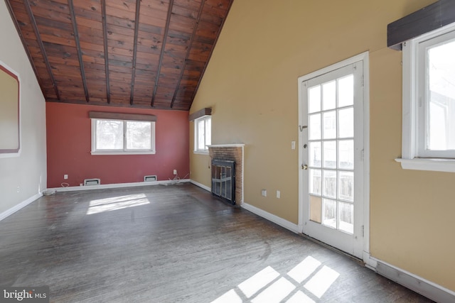 unfurnished living room with a fireplace, wood finished floors, wood ceiling, baseboards, and vaulted ceiling