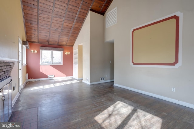 unfurnished living room featuring a brick fireplace, wooden ceiling, baseboards, and wood finished floors