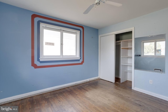 unfurnished bedroom with a ceiling fan, a closet, baseboards, and wood finished floors