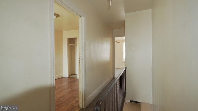 corridor featuring wood finished floors