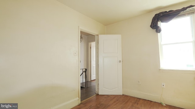 unfurnished bedroom featuring baseboards and wood finished floors