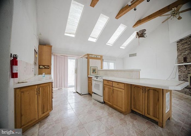 kitchen with white electric stove, a peninsula, a skylight, light countertops, and beamed ceiling