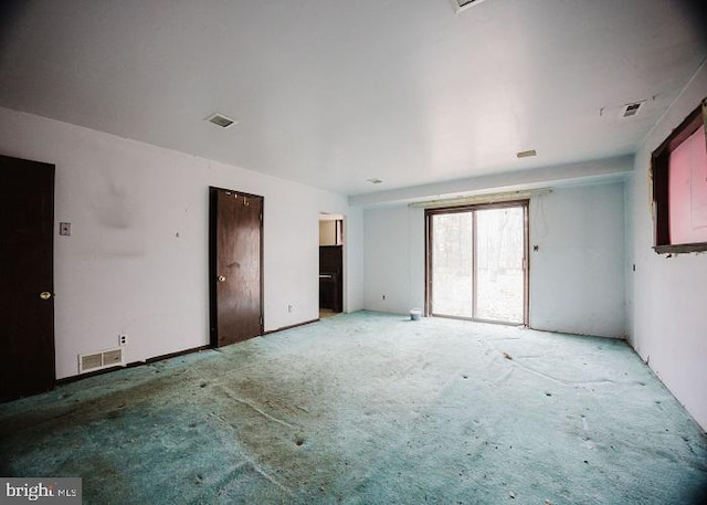 unfurnished bedroom featuring access to exterior and visible vents