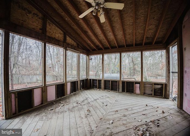 unfurnished sunroom featuring vaulted ceiling and a ceiling fan