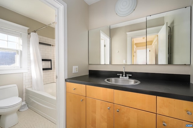 full bath with tile patterned flooring, shower / tub combo with curtain, vanity, and toilet