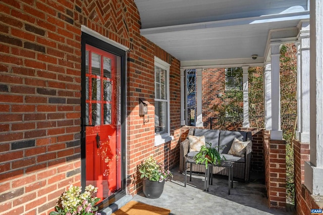 exterior space with covered porch and brick siding