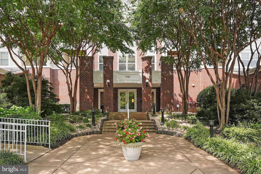 view of front of property featuring french doors and brick siding