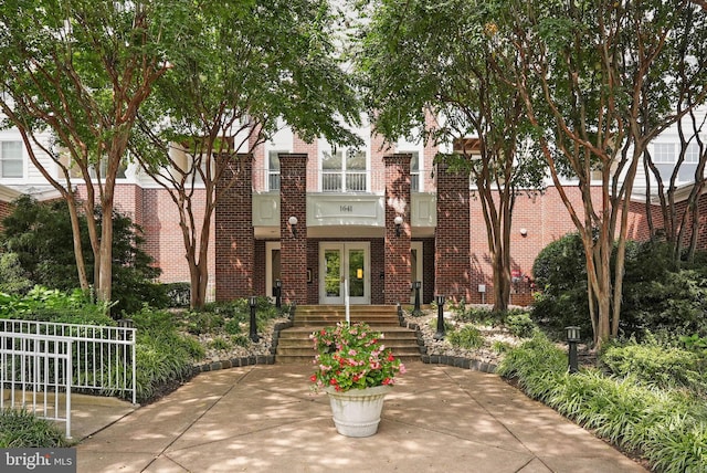 view of front of home featuring french doors and brick siding