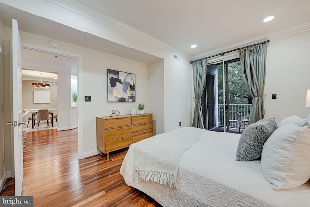 bedroom featuring visible vents, crown molding, and wood finished floors