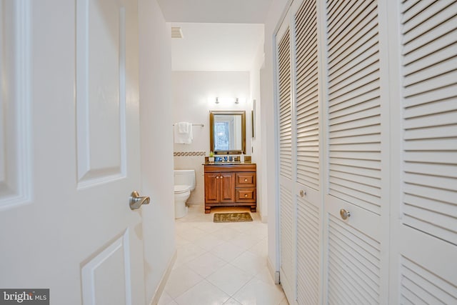 hallway with light tile patterned floors and visible vents