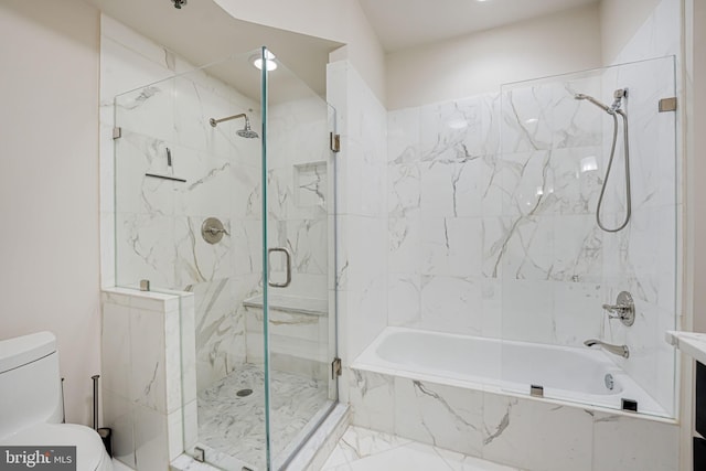 bathroom featuring tiled shower / bath, marble finish floor, and toilet