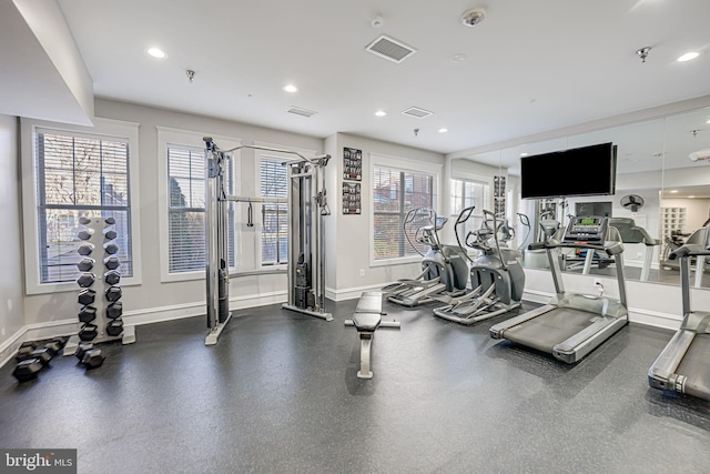 exercise room with a healthy amount of sunlight, baseboards, and recessed lighting