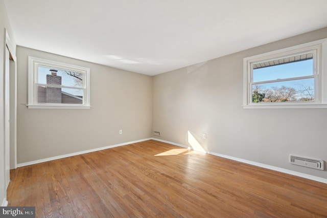 unfurnished room featuring baseboards and wood finished floors