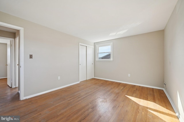 empty room with wood finished floors and baseboards