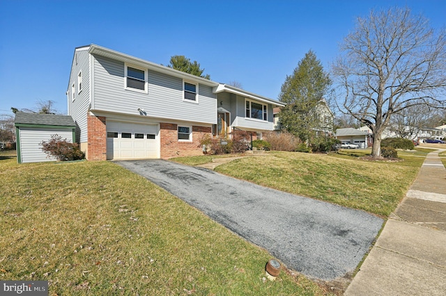 view of front of house with aphalt driveway, a garage, brick siding, and a front yard