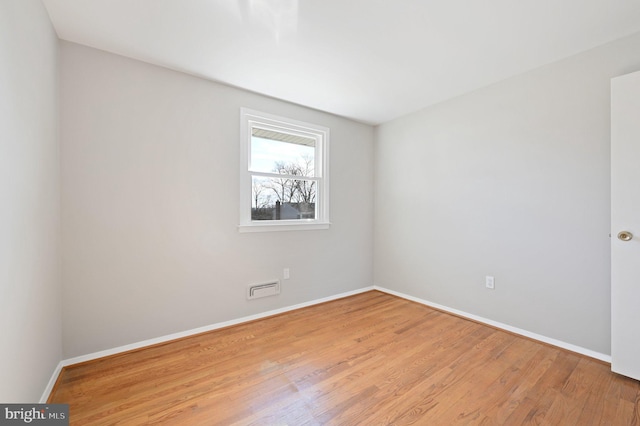 unfurnished room featuring visible vents, baseboards, and light wood-style flooring