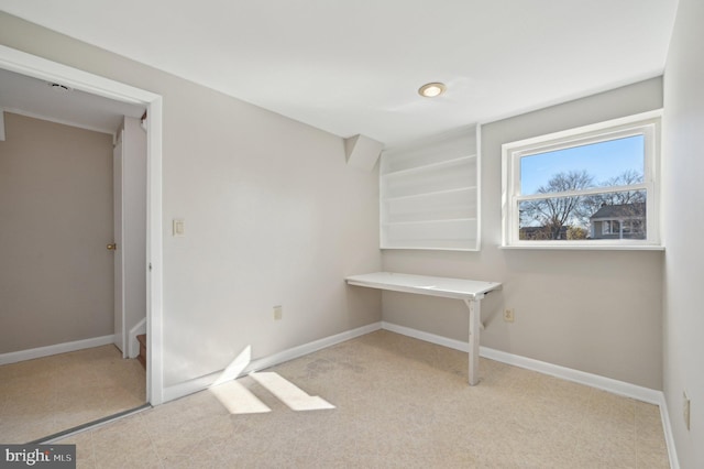 interior space featuring baseboards