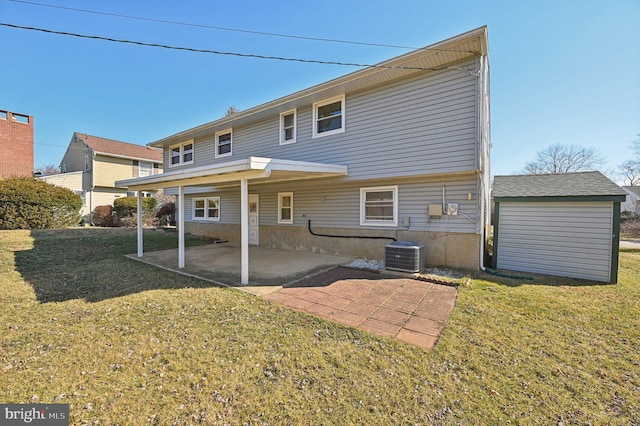 back of property with a patio area, central AC unit, and a lawn