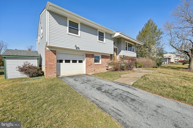 view of front of property featuring brick siding, an attached garage, aphalt driveway, and a front yard