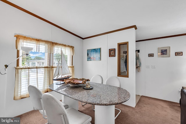 dining room with carpet floors, crown molding, and lofted ceiling