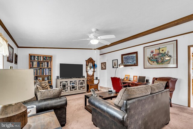 living room featuring ornamental molding, a ceiling fan, and light colored carpet