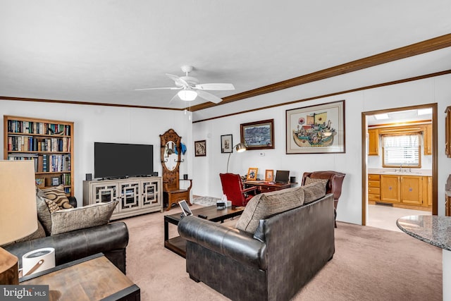 living area featuring ornamental molding, light colored carpet, and a ceiling fan