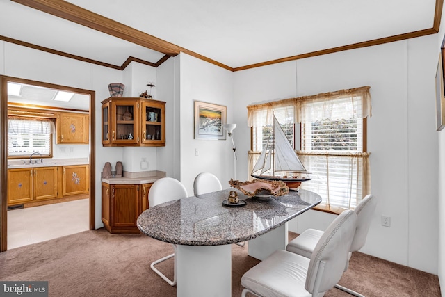 dining space with light carpet and ornamental molding