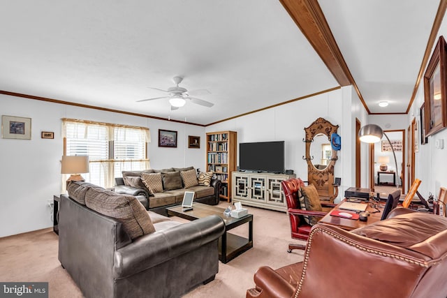 living area with ornamental molding, light carpet, and ceiling fan