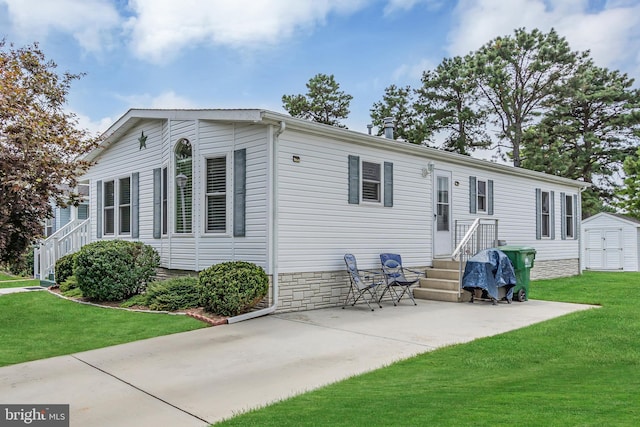 back of property with a storage unit, a lawn, and an outdoor structure