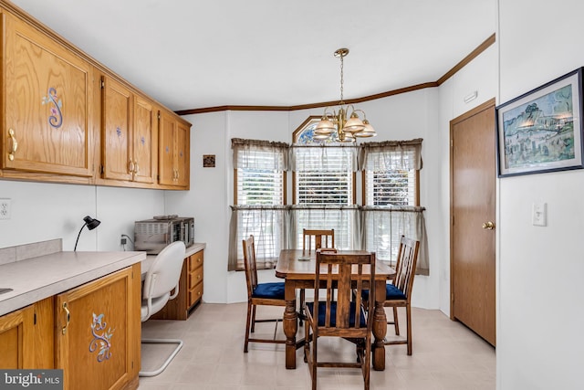 dining area with an inviting chandelier and ornamental molding