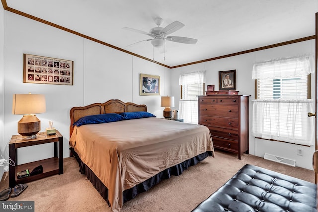 bedroom featuring carpet floors, visible vents, crown molding, and multiple windows