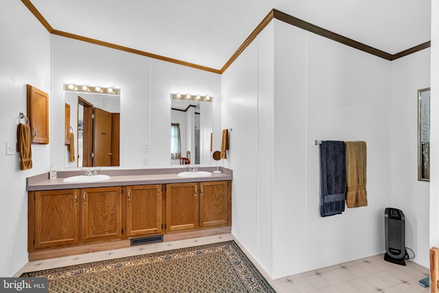 bathroom with double vanity, crown molding, and a sink