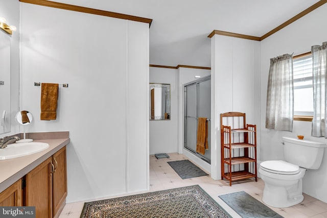 bathroom with vanity, ornamental molding, a shower stall, and toilet