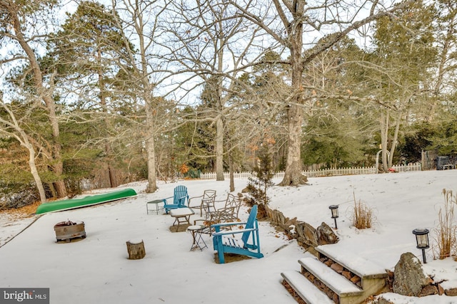 view of patio with an outdoor fire pit and fence