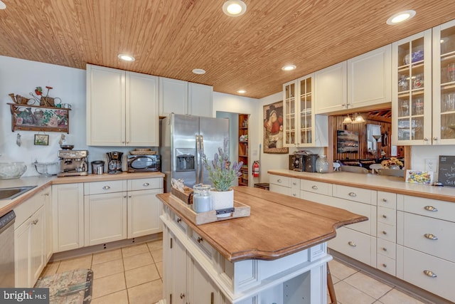 kitchen featuring stainless steel appliances, recessed lighting, wood ceiling, light tile patterned flooring, and white cabinets