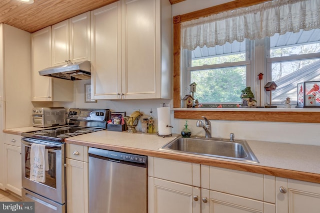 kitchen featuring stainless steel appliances, a sink, light countertops, and under cabinet range hood