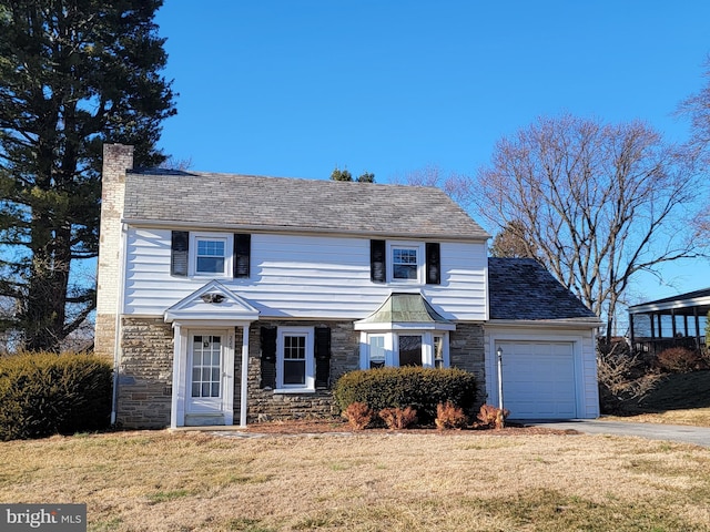 view of front facade featuring a garage, stone siding, a chimney, and a front lawn