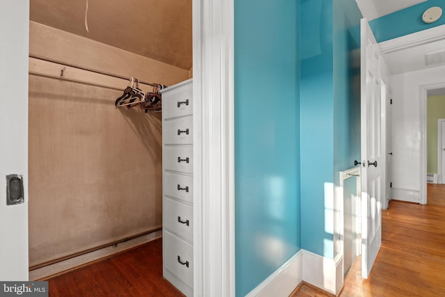 interior space featuring baseboard heating, wood finished floors, and visible vents