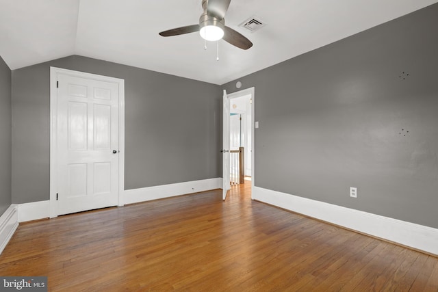 unfurnished bedroom featuring wood-type flooring, visible vents, and baseboards