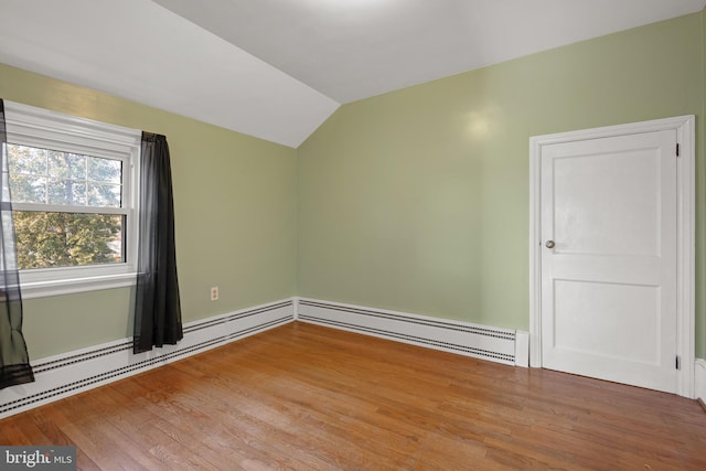 spare room with lofted ceiling and wood finished floors