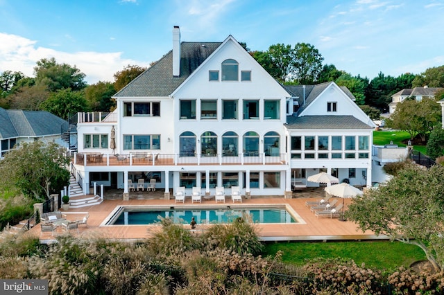 803 Coachway, Annapolis, MD 21401 - back of property featuring a patio, an outdoor pool, outdoor dining area, a balcony, and a chimney